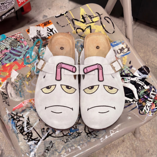 Master Shake clogs on graffiti chair
