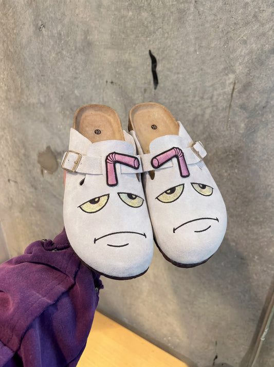 Master Shake clogs — front view, grumpy embroidered face with pink straw